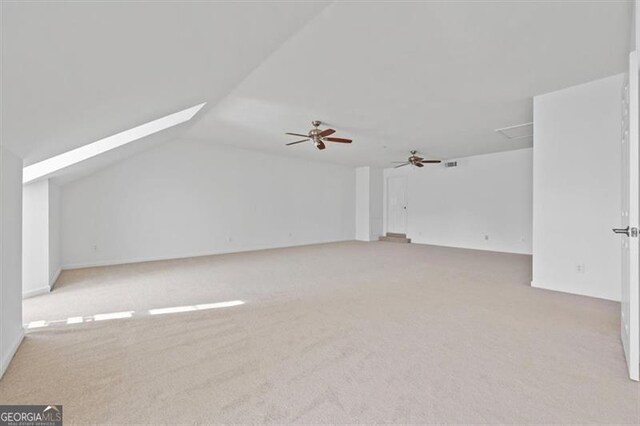 bonus room with light carpet, ceiling fan, and vaulted ceiling