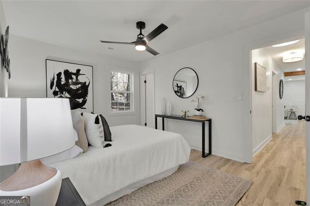 bedroom with ceiling fan and light hardwood / wood-style floors