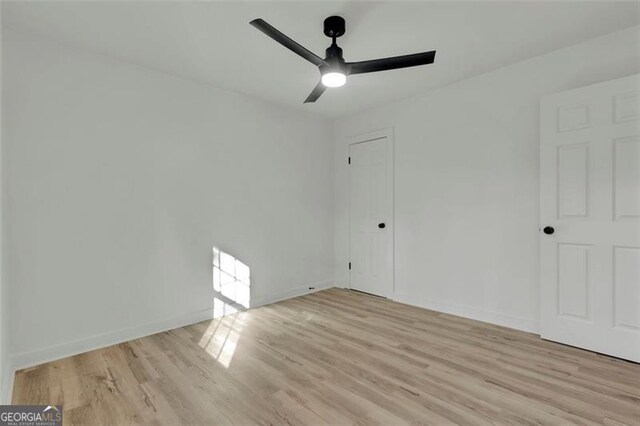 empty room featuring ceiling fan and light wood-type flooring