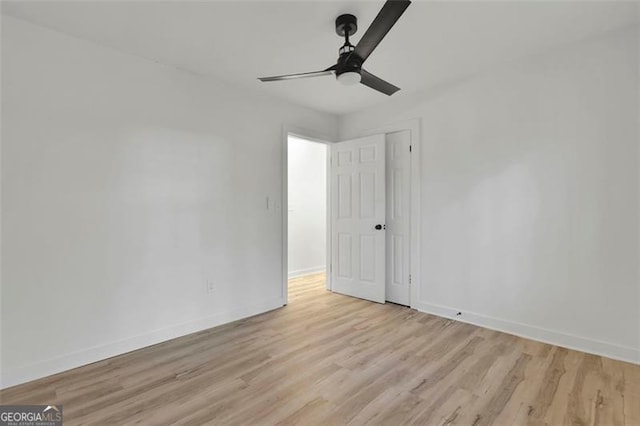 empty room with ceiling fan and light wood-type flooring