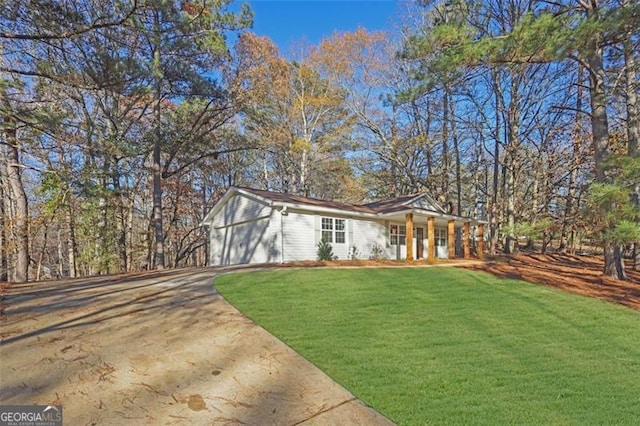 view of front of property featuring a garage and a front lawn