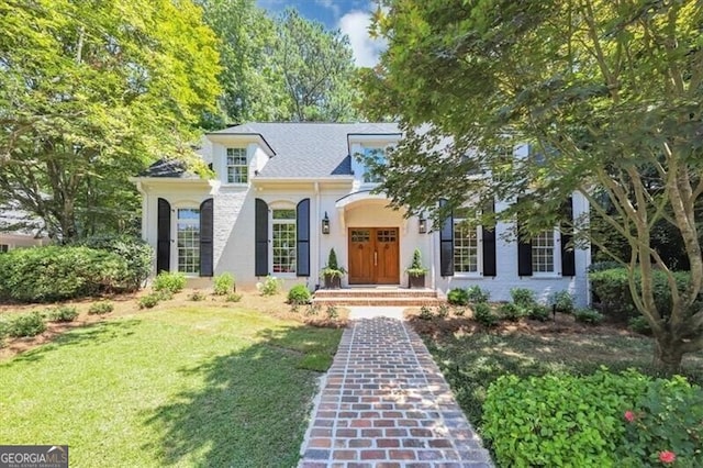 mediterranean / spanish house featuring a front yard