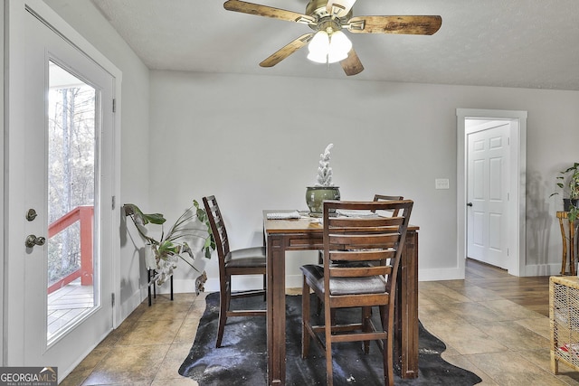 dining space featuring a textured ceiling, tile patterned floors, and ceiling fan