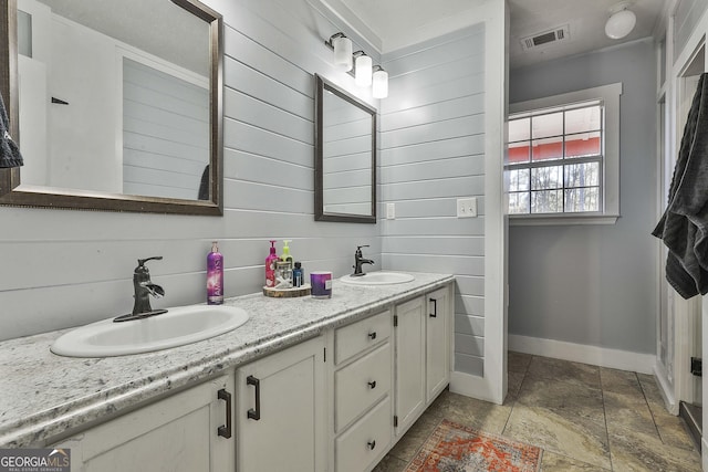 bathroom featuring vanity and wood walls