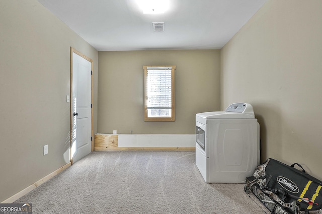 clothes washing area featuring washer / dryer and light carpet