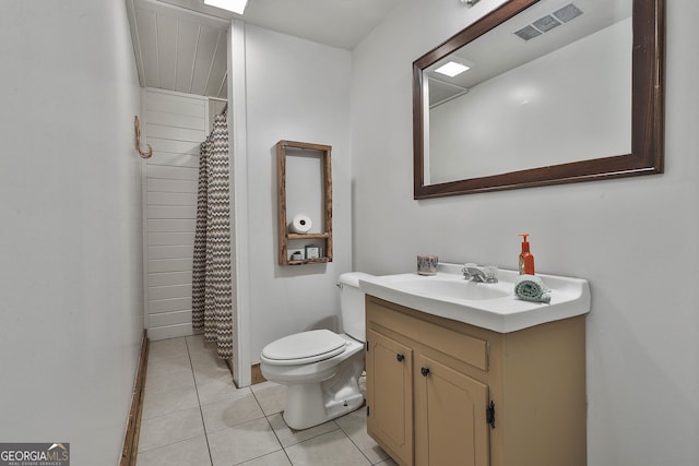 bathroom featuring toilet, a shower with curtain, vanity, and tile patterned floors