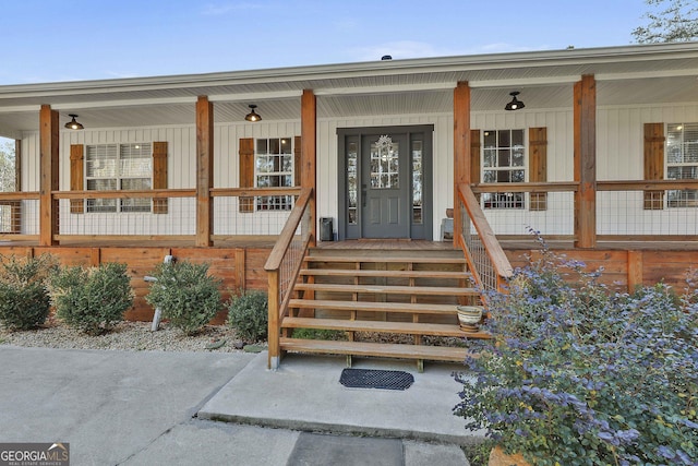 doorway to property featuring covered porch