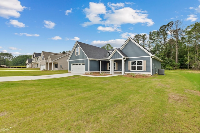 view of front of home featuring central AC, a front yard, and a garage