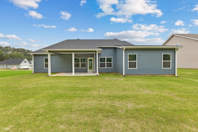 back of house featuring a yard and a patio