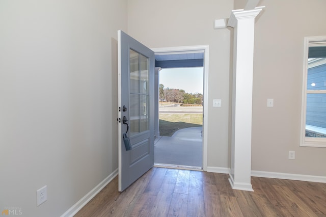 foyer entrance with wood-type flooring and ornate columns