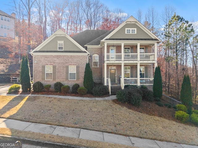 view of front facade with covered porch and a balcony