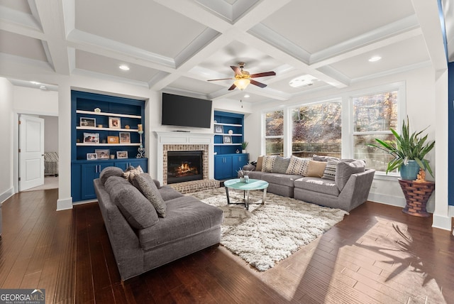 living room with built in shelves, beam ceiling, dark wood-type flooring, and coffered ceiling