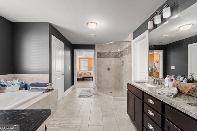 bathroom featuring tile patterned flooring, vanity, and separate shower and tub