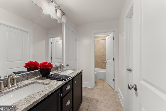 bathroom featuring tile patterned floors, vanity, and toilet