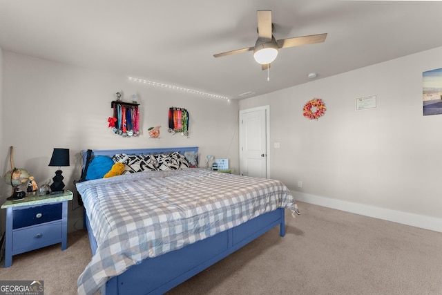 bedroom featuring light carpet and ceiling fan