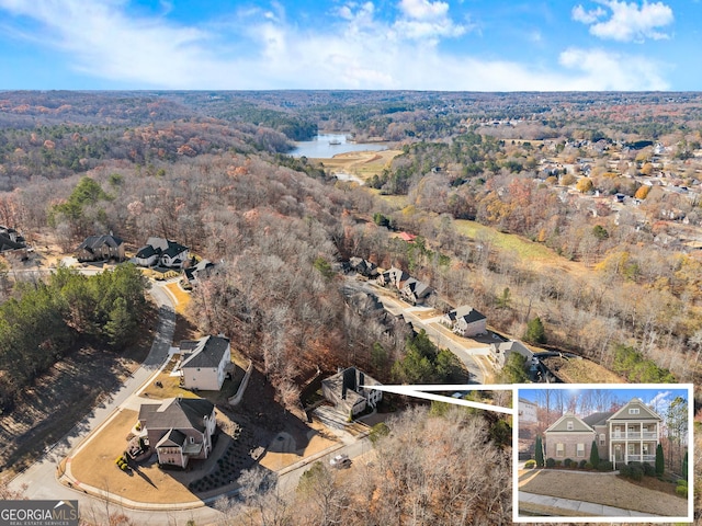 birds eye view of property with a water view