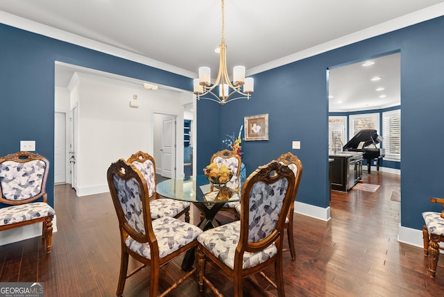 dining area featuring a chandelier, crown molding, and dark wood-type flooring