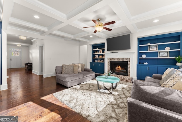 living room with built in features, beamed ceiling, and dark hardwood / wood-style floors