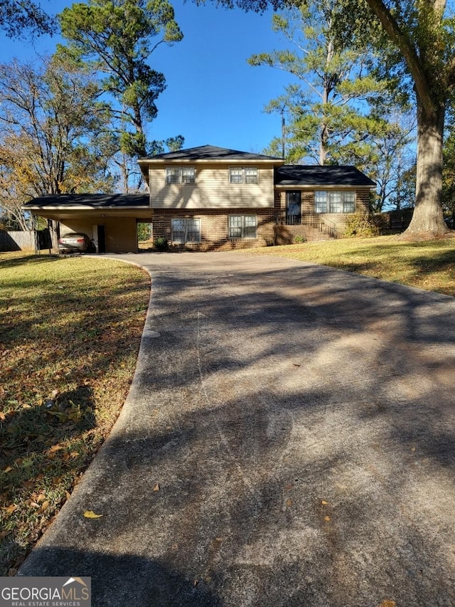 view of front facade with a carport and a front lawn