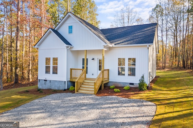 modern farmhouse style home with a front lawn