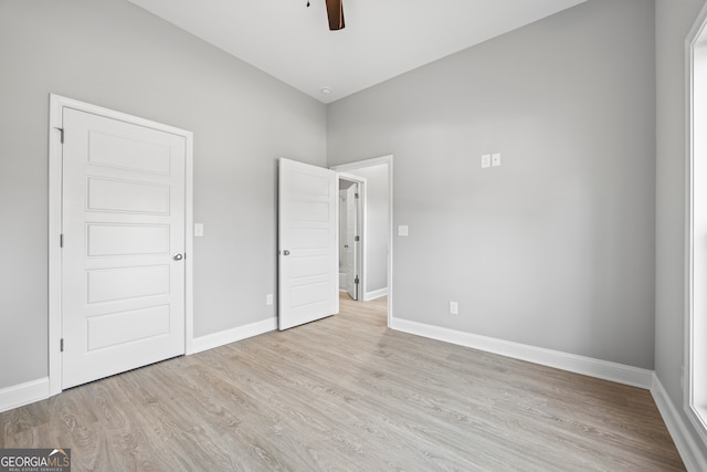 unfurnished bedroom featuring light wood-type flooring and ceiling fan