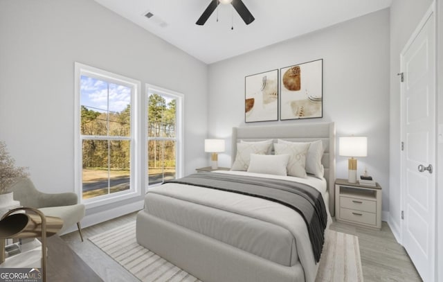 bedroom with ceiling fan and light hardwood / wood-style flooring