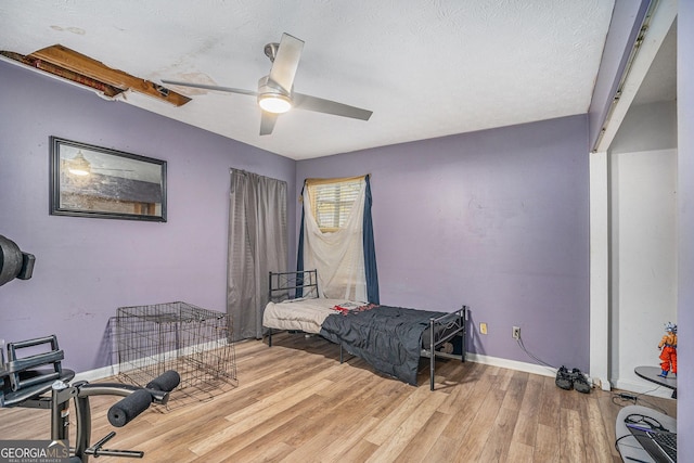 bedroom featuring a textured ceiling, hardwood / wood-style flooring, and ceiling fan