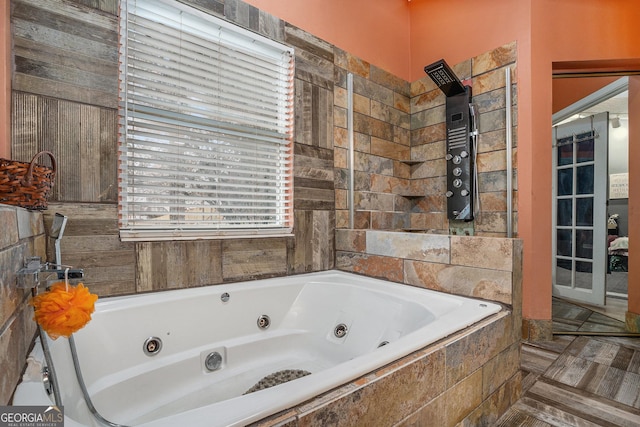 bathroom with a relaxing tiled tub