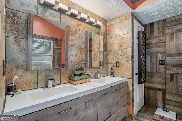 bathroom featuring tile walls, vanity, a textured ceiling, and hardwood / wood-style flooring