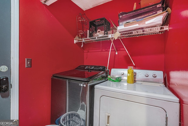 laundry room with washing machine and clothes dryer