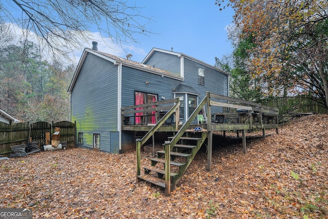 rear view of property with a wooden deck