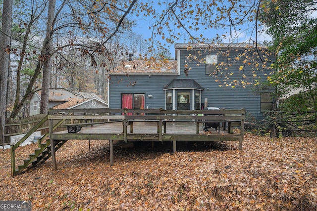 back of house with a wooden deck