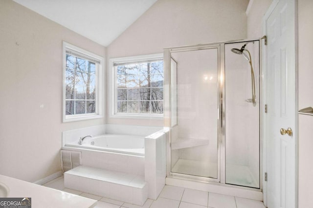 bathroom with tile patterned flooring, plus walk in shower, and vaulted ceiling