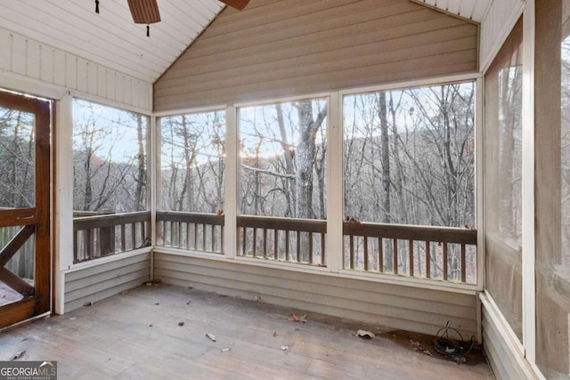 unfurnished sunroom with ceiling fan, wooden ceiling, and vaulted ceiling