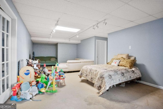 carpeted bedroom featuring a paneled ceiling