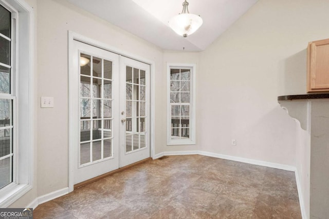 unfurnished dining area with french doors and lofted ceiling