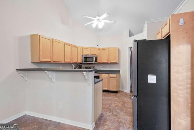 kitchen featuring ceiling fan, stainless steel appliances, a kitchen breakfast bar, high vaulted ceiling, and kitchen peninsula