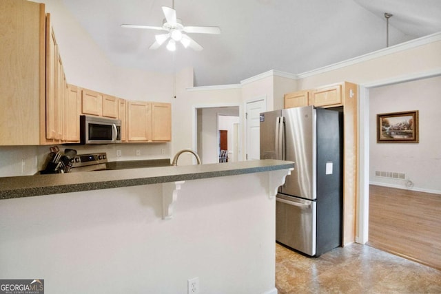 kitchen with a breakfast bar, light brown cabinetry, stainless steel appliances, and kitchen peninsula