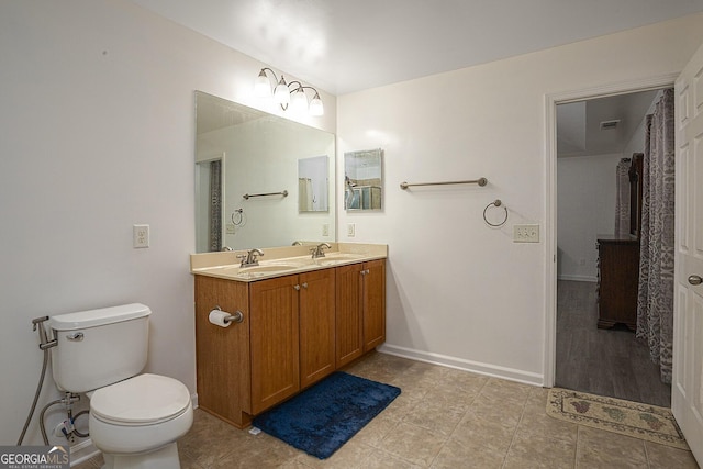 bathroom with tile patterned flooring, vanity, and toilet