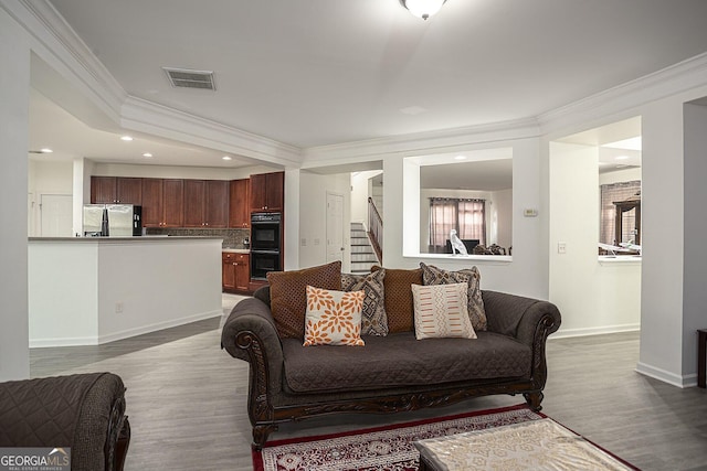 living room with dark hardwood / wood-style floors and ornamental molding