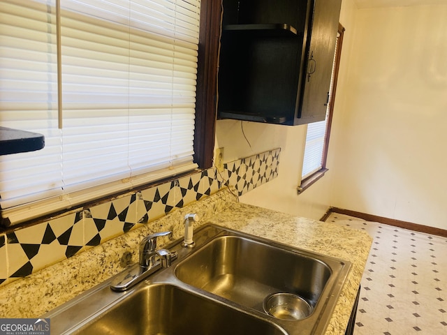 interior details featuring light stone counters and sink