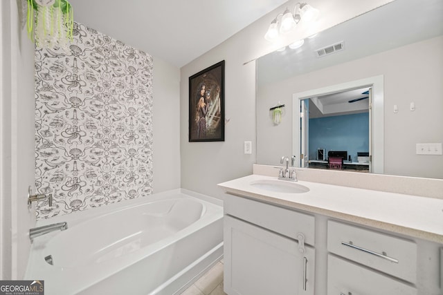 bathroom with tile patterned floors, vanity, and a washtub