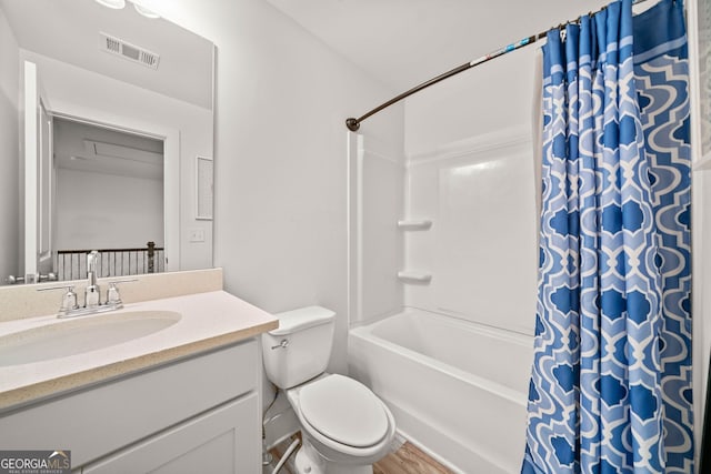 full bathroom with toilet, vanity, hardwood / wood-style flooring, and shower / tub combo with curtain