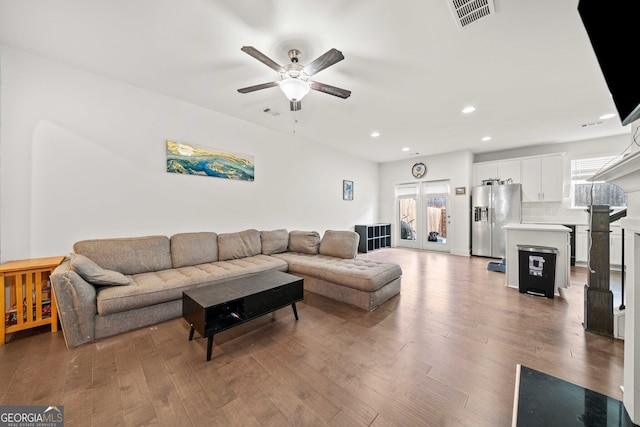 living room featuring dark hardwood / wood-style floors and ceiling fan