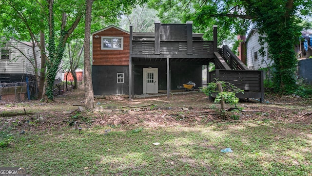 back of house with a wooden deck