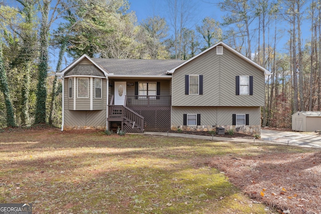 view of front of house with a porch, central AC unit, a front yard, and a storage shed