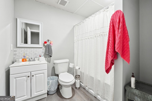 bathroom featuring tasteful backsplash, wood-type flooring, toilet, vanity, and a shower with shower curtain