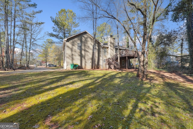 back of house with a yard and a wooden deck