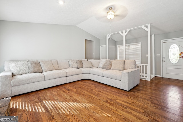 unfurnished living room featuring a textured ceiling, ceiling fan, dark hardwood / wood-style flooring, and vaulted ceiling