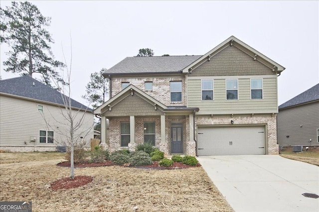 craftsman-style house featuring central AC unit, a garage, and covered porch